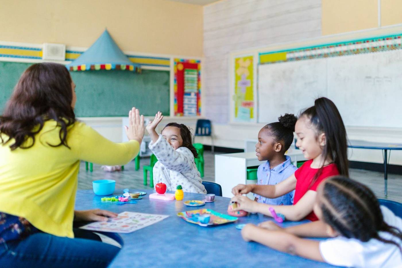 Children learning with their teacher at Little Lanterns