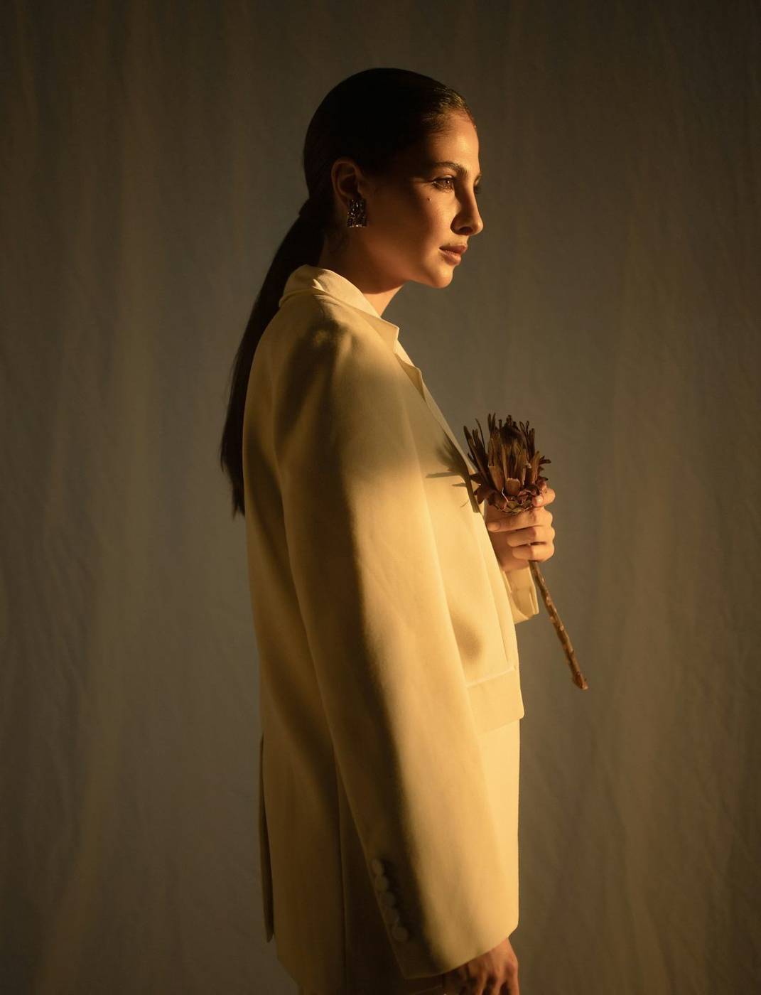 Model in an ochre linen coat