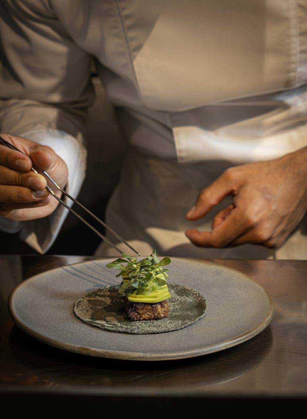 Chef plating with tweezers