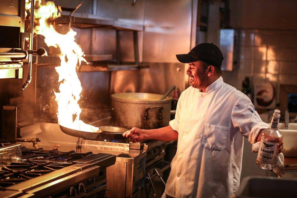 Flames rising from the grill as the chef cooks