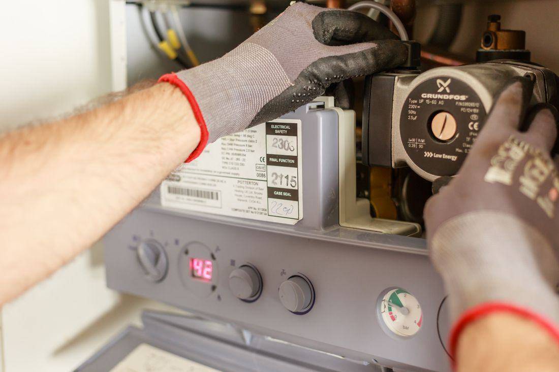 Plumber adjusting a water heater